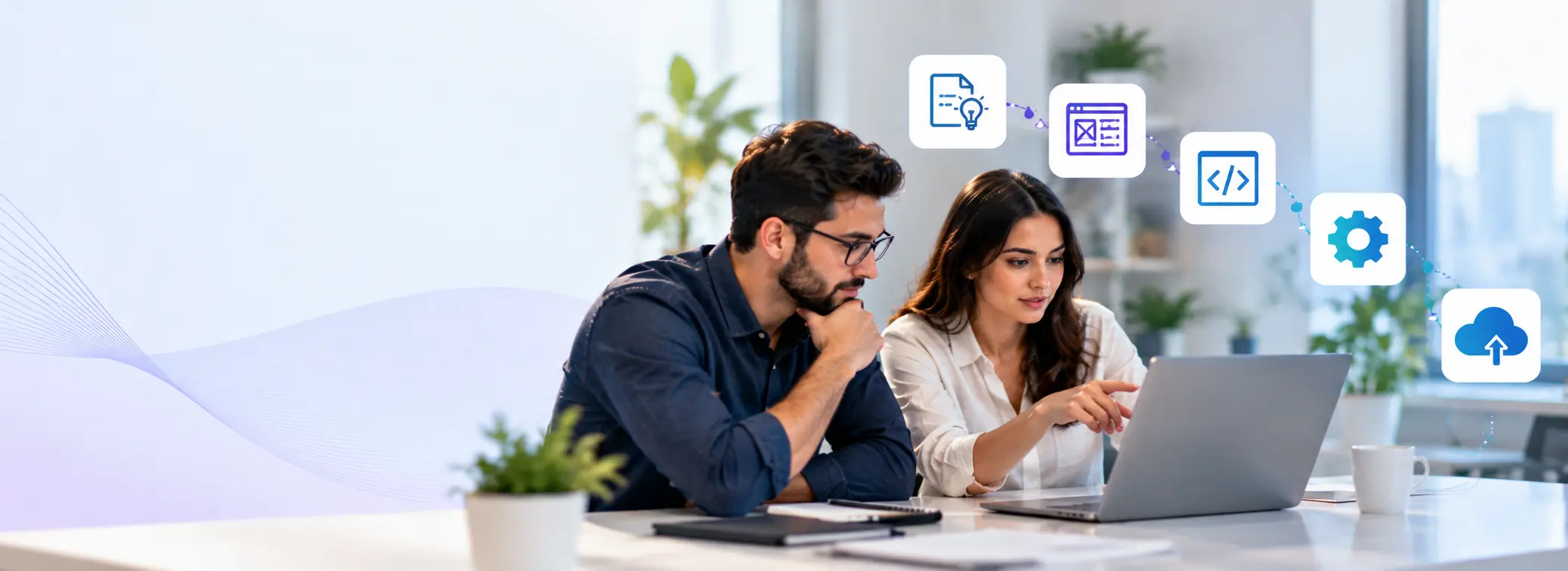 Software development team reviewing a project workflow on a laptop
